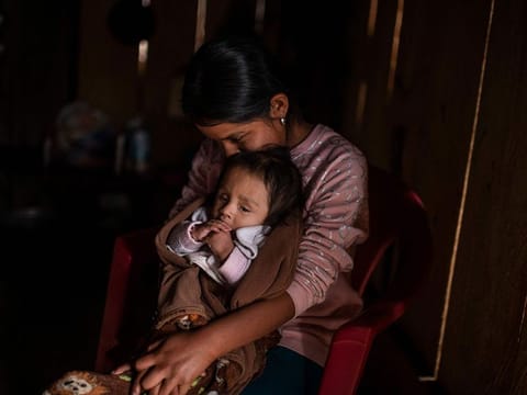 Cristina Moreno, 18, holds her baby at her home in Juvinani village, Metlatonoc  municipality, Guerrero state, Mexico, on May 16, 2021. 