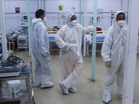 Health workers keep a watch on patients in a ward at the BKC jumbo field hospital, one of the largest COVID-19 facilities in Mumbai, India, Friday, May 7, 2021. 