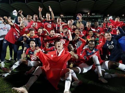 Lille players and coaches celebrate after winning French League One.