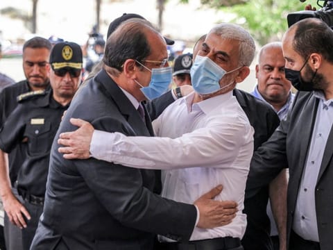 Yahya Sinwar (left), Hamas' political chief in Gaza, embraces General Abbas Kamel (right), Egypt's intelligence chief, as the latter arrives for a meeting with leaders of Hamas in Gaza City on May 31, 2021. 