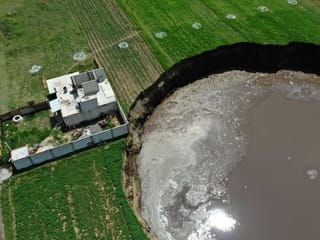 Photos: Huge sinkhole threatens to swallow Mexican home