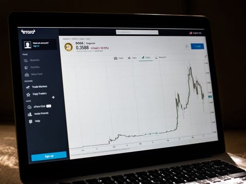 Dogecoin prices on the EToro website on a laptop computer arranged in Dobbs Ferry, New York, U.S., on Saturday, May 22, 2021.