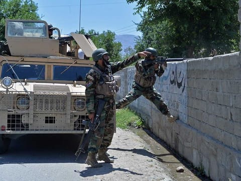 Members of Afghan security forces take their positions during an ongoing clash between Taliban and Afghan forces in Mihtarlam, the capital of Laghman Province on May 24, 2021, as the militants pressed on with their campaign to seize new territories as the US military continued with its troop pullout. 