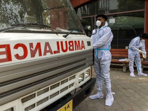 Health workers wear personal protective equipment (PPE) as they prepare to carry the body of a person, who died from complications related to the coronavirus disease (COVID-19), for cremation at a crematorium in New Delhi, India, June 10, 2021.