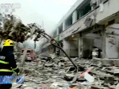In this image taken from a video footage run by China's CCTV, a firefighter walks near the aftermath of a gas explosion in Shiyan city in central China's Hubei Province on Sunday, June 13, 2021. 