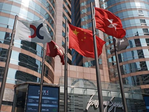 File photo: Flags are raised outside the Hong Kong Exchange Square building in Central of Hong Kong.