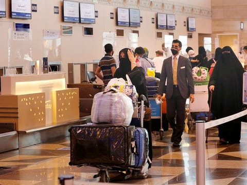 Saudi passengers prepare to check-in for flights at the King Abdulaziz International Airport in Jeddah, Saudi Arabia.