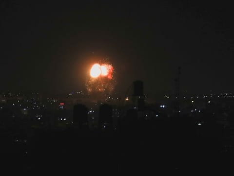 Smoke and flames are seen after an Israeli air strike in the northern Gaza Strip, June 17, 2021. 