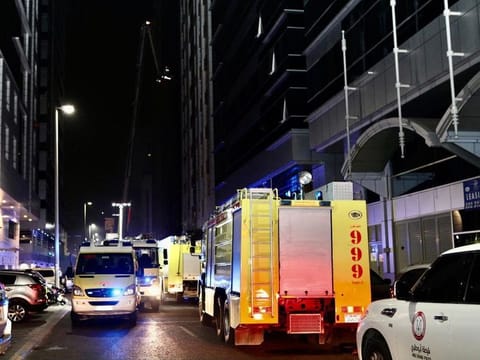 Fire engines from Abu Dhabi Civil Defence conducting firefighting operations at the building in Al Maamoura area on Thursday night.  