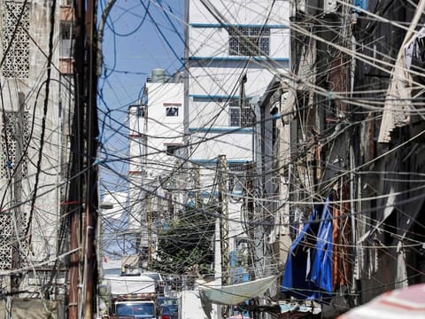 A view of a mesh of raised electricity lines along a street in a suburb of Lebanon's capital Beirut.