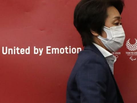 Tokyo 2020 Olympics Organizing Committee President Seiko Hashimoto leaves a news conference after a meeting with local municipalities working group hosted by the government in Tokyo on the day to mark one month to go until the opening of the Olympic Games.