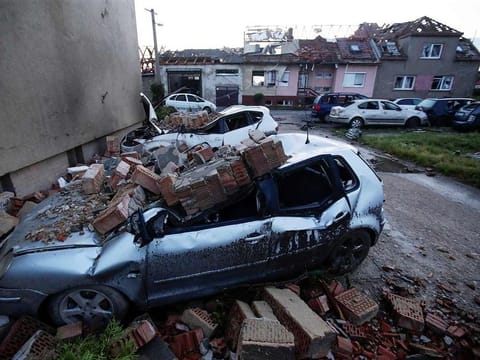 Damaged cars and houses are seen in the aftermath of a rare tornado that struck and destroyed parts of some towns, in the village of Moravska Nova Ves, Czech Republic, on June 25, 2021. 