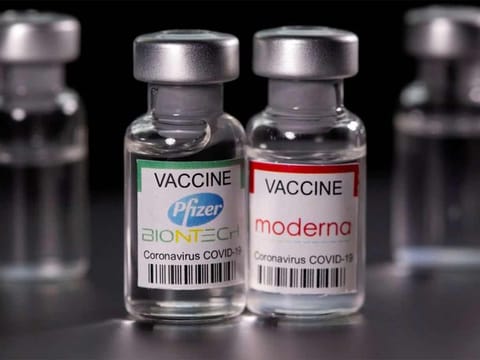 Vials with Pfizer-BioNTech and Moderna COVID-19 vaccine labels are seen in this illustration. 
