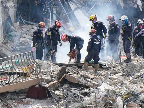 Crews work in the rubble at the Champlain Towers South Condo, in Surfside, Florida. Many people were still unaccounted for after Thursday's fatal collapse. 