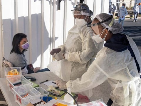 Health workers prepare to test a woman for COVID-19 at the Fourways Life Hospital in Johannesburg on June 28, 2021. 