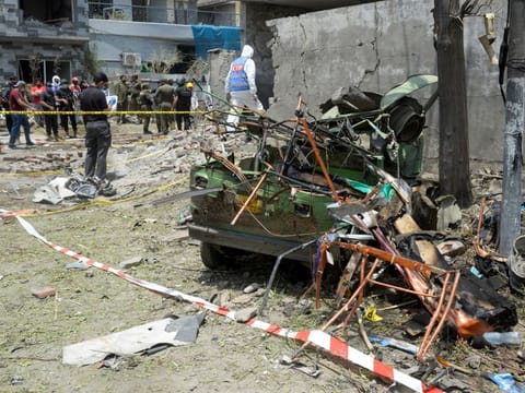 A member of the Counter Terrorism Department (CTD) surveys the site after the deadly blast in residential area in Lahore on June 23, 2021.  