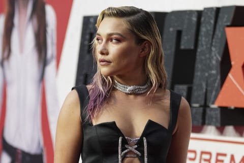 Florence Pugh poses for photographers upon arrival at a fan event for the film Black Widow in London, Tuesday, June 29, 2021.