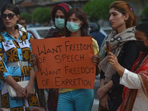 Civil society activists take part in a demonstration in Karachi on June 26, 2021 protesting against Pakistan Prime Minister's rape comments. women who make up half of the country’s population, continue to face legal barriers for women to access, own and administer property.  