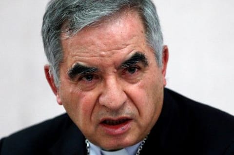 Cardinal Giovanni Angelo Becciu, who has been caught up in a real estate scandal, speaks to the media a day after he resigned suddenly and gave up his right to take part in an eventual conclave to elect a pope, near the Vatican, in Rome, on September 25, 2020. REUTERS/Guglielmo Mangiapane/File Photo