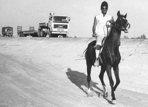 A young rider on his horse on the Dubai Abu Dhabi highway road - 16/12/1987