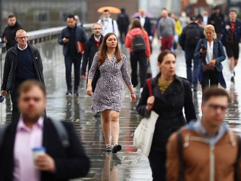 Commuters cross the London Bridge, on July 6, 2021. 
