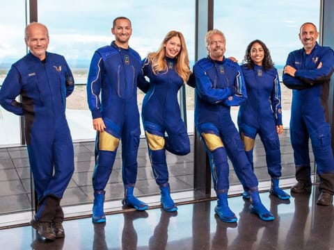 From left: Chief Pilot Dave Mackay, Lead Operations Engineer Colin Bennett,  Chief Astronaut Instructor Beth Moses, Founder of Virgin Galactic Richard Branson, Vice President of Government Affairs and Research Operations Sirisha Bandla and pilot Michael Masucci. Branson is aiming to beat fellow billionaire Jeff Bezos into space by nine days. 