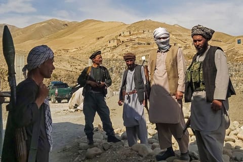 Afghan militia forces stand guard at an outpost as they patrol against the Taliban fighters in the Tange Farkhar area of Taloqan in northern Takhar province on July 6, 2021. 