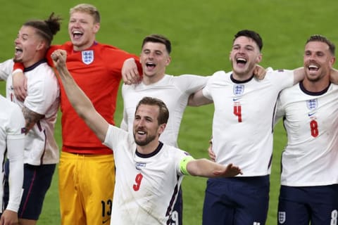 England's Harry Kane and his teammates celebrate at the end of the Euro 2020 championship semifinal match against Denmark at Wembley stadium in London. England won 2-1 to set up a final against Italy on Sunday night.
