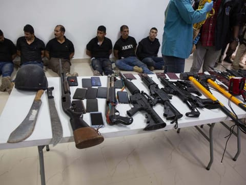 Suspects in the assassination of Haiti's President Jovenel Moise are shown to the media, along with the weapons and equipment they allegedly used in the attack, at the General Direction of the police in Port-au-Prince, Haiti, Thursday, July 8, 2021. Moise was assassinated in an attack on his private residence early Wednesday. 