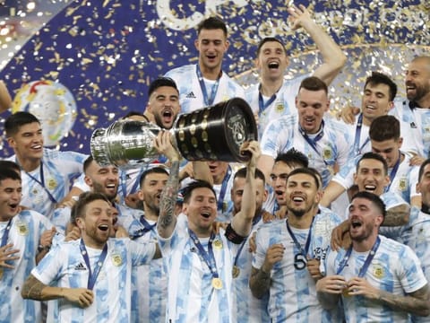 Argentina's Lionel Messi (centre) holds the trophy as he celebrates with teammates after beating 1-0 Brazil in the Copa America final at the Maracana stadium in Rio de Janeiro, Brazil. 