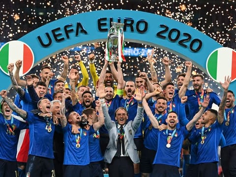 File photo: Italy’s team celebrates with the trophy on the podium after winning the Euro 2020 football championship final against England at Wembley stadium in London on July 11, 2021.