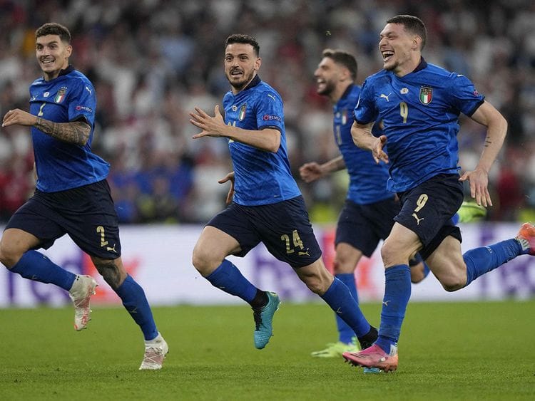 Italy players celebrate the penalty shootout win over England