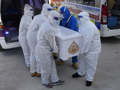 Siam Nonthaburi Foundation volunteers in full protective suits carrying coffin a COVID-19 victim for free  funeral ceremony service at Wat Ratprakongtham temple Nonthaburi Province, Thailand, on July 12, 2021. 
