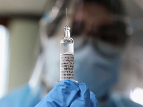 A medical worker holds a dose of Biokangtai's coronavirus disease (COVID-19) vaccine during a vaccination programme at a factory, in Pulau Indah, Malaysia July 8, 2021. 