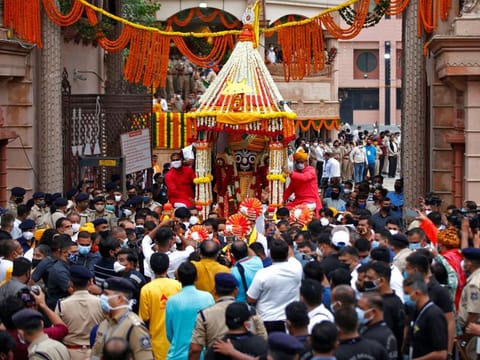 Hindu devotees pull a "Rath" or a chariot of Lord Jagannath, outside a temple during the annual Rath Yatra, or chariot procession, in Ahmedabad on July 12, 2021. 