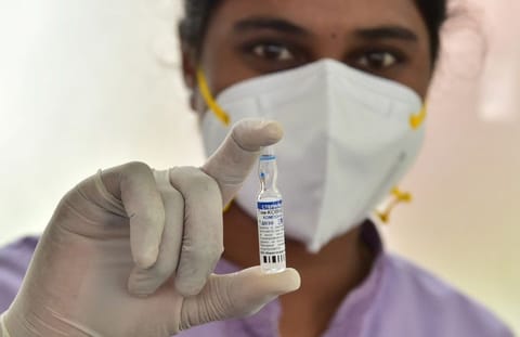 A medic shows a vial of the Covid-19 Sputnik V vaccine during its launch in Bengaluru, on June 29, 2021. 