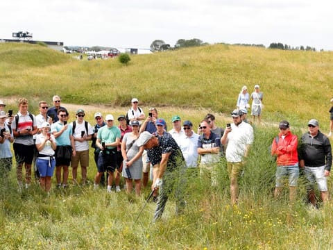 Bryson DeChambeau of the US in action in the rough on the ninth fairway during the first round of British Open, which opened its doors to fans on Thursday.