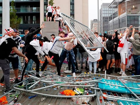 England fans throw barriers outside Wembley Stadium during the Euro 2020 final against Italy.