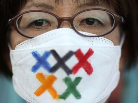 A person protests against having the Olympics in Tokyo, Japan, due to the COVID-19 pandemic. 