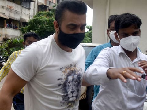 Police escort arrested Bollywood star Shilpa Shetty's husband Raj Kundra (L) for allegedly producing and broadcasting pornographic films online, in Mumbai on July 20, 2021.