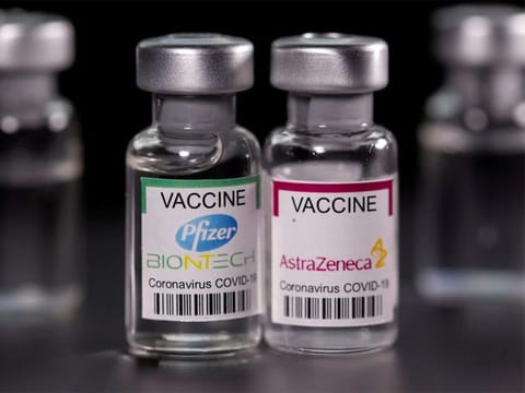 Vials with Pfizer-BioNTech and AstraZeneca COVID-19 vaccine labels are seen in this illustration. 