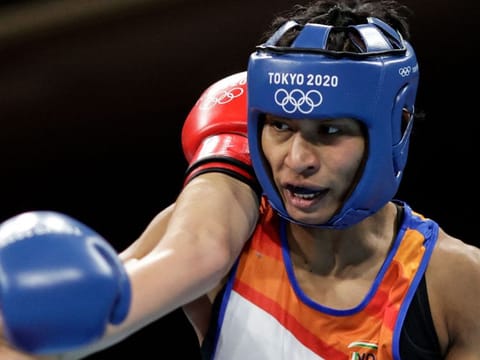 India's Lovlina Borgohain (right) had the measure of Germany's Nadine Apetz (partly hidden) during their women's welterweight preliminaries round-of-16 match in Tokyo on Tuesday.