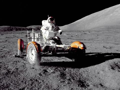 Apollo 17 mission commander Eugene A. Cernan makes a short checkout of the Lunar Roving Vehicle during the early part of the first Apollo 17 extravehicular activity at the Taurus-Littrow landing site. This view of the lunar rover prior to loadup was taken by Harrison H. Schmitt, Lunar Module pilot. The mountain in the right background is the east end of South Massif.