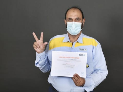  A Dubai taxi driver with his certificate after successful completion of the Dubai Way training programme.