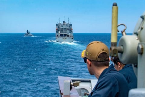 FILE - Guided-missile cruiser and the coastal patrol ship as they transit the Strait of Hormuz.
