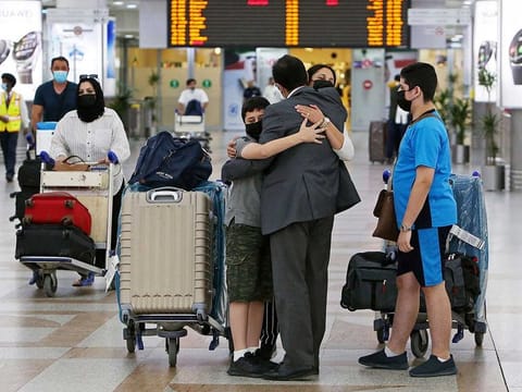 A man greets his family upon their arrival at Kuwait international airport in a file photo.