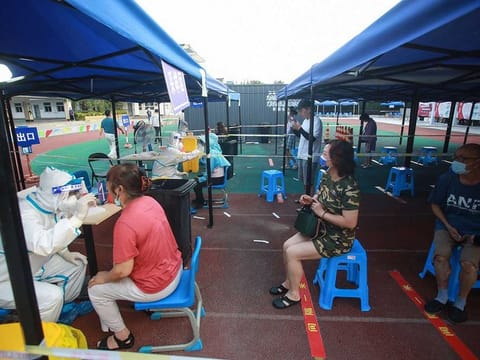 This photo taken on August 1, 2021 shows residents queueing to receive nucleic acid tests for the COVID-19 in Yangzhou in China's eastern Jiangsu province, amid the country's most widespread coronavirus outbreak in months. 