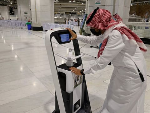A Saudi man works on a smart sterilising robot at the Grand Mosque in of Mecca during the Hajj pilgrimage.