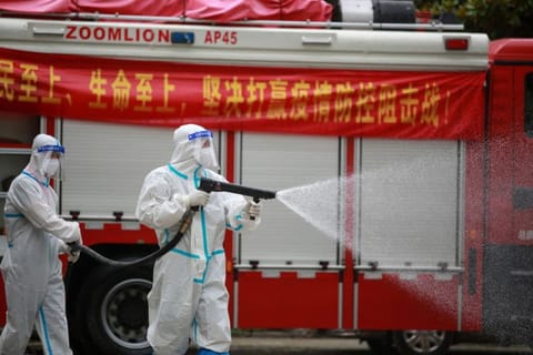 A firefighter sprays disinfectant at a residental area in Yangzhou, in China's eastern Jiangsu province on August 11, 2021.