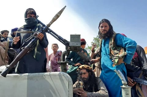 Taliban fighters in a vehicle on a street in Laghman province on August 15, 2021.
